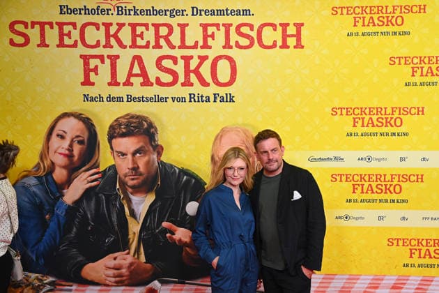 Sebastian BEZZEL, actor, with his wife Johanna Christine GEHLEN, actress, at the world premiere of *STECKERLFISCHFIASKO* on August 10, 20226, at the Mathaeser Kino in Munich. Red Carpet