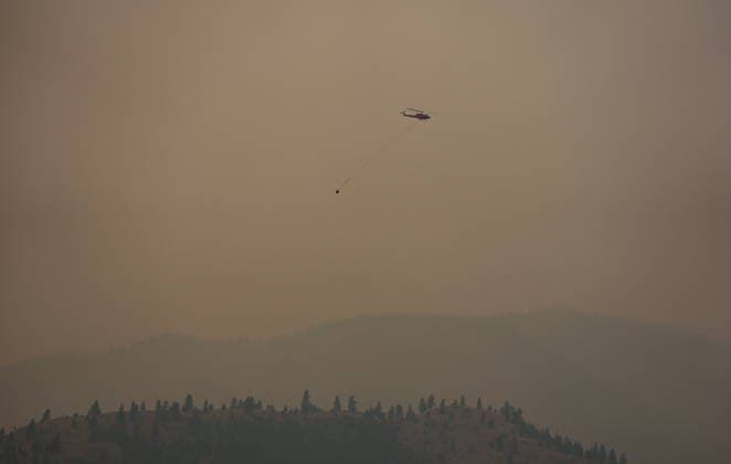 August 10, 2026, Penticton, Bc, CANADA: A helicopter being used to battle the Bald Range wildfire takes off from the Penticton Regional Airport, in Penticton, B.C., on Monday, Aug. 10, 2026. Penticton CANADA  - ZUMAc35_ 20260810_zaf_c35_027 Copyright: xDarrylxDyckx