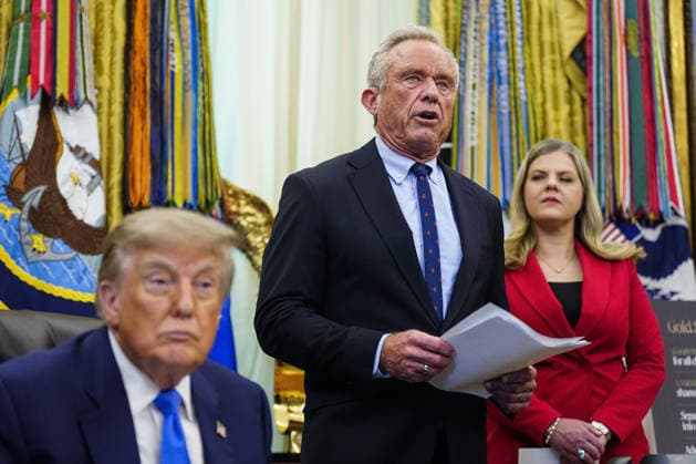 US Health and Human Services Secretary Robert F. Kennedy Jr. (C) speaks before President Donald Trump (L) signs an executive order that reevaluates childhood vaccines in the Oval Office of the White House in Washington, DC on August 10, 2026. While the executive order still recommends childhood vaccines for 11 diseases, including measles and polio, it calls for limiting vaccines for other diseases, like hepatitis A and B and meningococcal disease, to high-risk populations.  WAP20260810108 BONNIExCASH