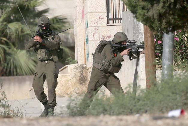 August 11, 2026, Nablus, West Bank, Palestine: Israeli soldiers aim their weapons and take up positions towards Palestinians during the demolition of a home. Israeli army demolished the home of a Palestinian accused of carrying out an armed attack that killed an Israeli soldier and a Jewish settler in the village of Tell. Nablus Palestine - ZUMAs197 20260811_aaa_s197_004 Copyright: xNasserxishatyehx