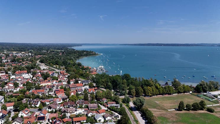 A summer day in Dießen on Lake Ammersee, Landsberg am Lech District. Here is a view of the town from above: cityscape, townscape, skyline, view of the houses; Lake Ammersee is on the right.