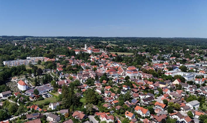 A summer day in Dießen on Lake Ammersee, Landsberg am Lech District. Here is a view of the town from above: a cityscape, townscape, skyline, and view of the houses; in the center of the image is the monastery, the Cathedral of the Assumption of Mary.