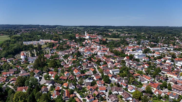 A summer day in Dießen on Lake Ammersee, Landsberg am Lech District. Here is a view of the town from above: a cityscape, townscape, skyline, and view of the houses; in the center of the image is the monastery, the Cathedral of the Assumption of Mary.