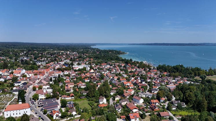 A summer day in Dießen on Lake Ammersee, Landsberg am Lech District. Here is a view of the town from above: cityscape, townscape, skyline, view of the houses; Lake Ammersee is on the right.