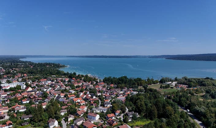 A summer day in Dießen on Lake Ammersee, Landsberg am Lech District. Here is a view of the town from above: cityscape, townscape, skyline, view of the houses; Lake Ammersee is on the right.