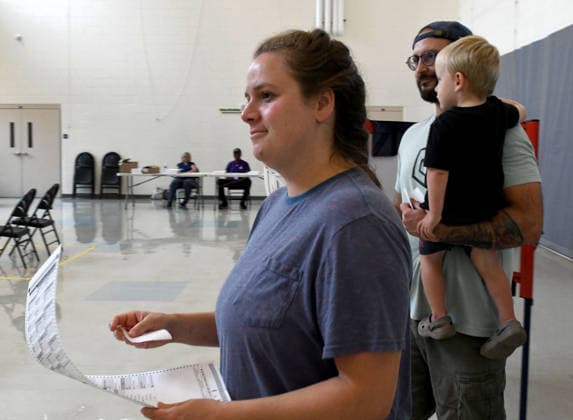 August 11, 2026, Racine, Wisconsin, USA: ALEXANDRIA and TYLER SCHEER, with their son CALLAHAN, 2, vote at Fratt Elementary School in Racine in the Wisconsin primary election Tuesday August 11, 2026. National focus is on the Democratic gubernatorial primary and on efforts to flip several Republican congressional seats, including that of incumbent Bryan Steil who represents the First Congressional District, including Racine County. Racine USA - ZUMAh154 20260811_znp_h154_013 Copyright: xMarkxHertzbergx