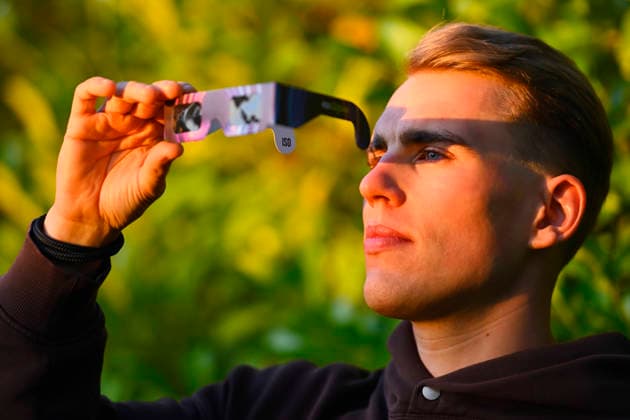 Young man wearing protective glasses for the solar eclipse in Hamburg, Germany Hamburg Hamburg Germany ** FOR EDITORIAL PURPOSES ONLY ** EDITORIAL USE ONLY **