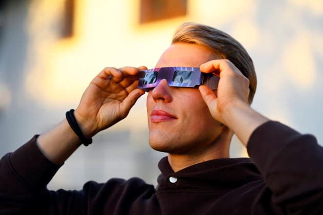 Young man wearing protective glasses for the solar eclipse in Hamburg, Germany Hamburg Hamburg Germany ** FOR EDITORIAL PURPOSES ONLY ** EDITORIAL USE ONLY **