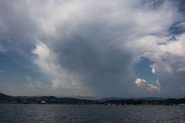 August 12, 2026, La Spezia, Italy: LA SPEZIA, ITALY †AUGUST 12, 2026: A towering cumulonimbus cloud rises over the Gulf of La Spezia on August 12, 2026, hours after a magnitude 3.7 earthquake struck off the northern Tuscan coast. Boats navigate the Gulf of La Spezia as dramatic storm clouds build over the Ligurian coast on August 12, 2026. Earlier in the day, a magnitude 3.7 earthquake struck off the northern Tuscan coast at 10:57 a.m. local time at a depth of about 9 kilometres, shaking parts of Liguria and Tuscany, including La Spezia, with no damage or injuries reported. Residents and visitors later gathered along the coast to observe a partial solar eclipse visible shortly before sunset. La Spezia Italy - ZUMAq101 20260812_zna_q101_181 Copyright: xGianxMarcoxBenedettox