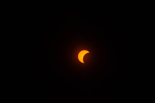 August 12, 2026, Nijmegen, Netherlands: The moon is starting to cover the sun. On the banks of the Waal River in Nijmegen, people gathered to watch the partial solar eclipse. The solar eclipse began at 7:16 PM, with 88% of the sun eclipsed by 8:11 PM. This is the largest partial solar eclipse the Netherlands has seen since 1999; the next one of this magnitude will be in 2081. Nijmegen Netherlands - ZUMAs197 20260812_aaa_s197_196 Copyright: xAnaxFernandezx