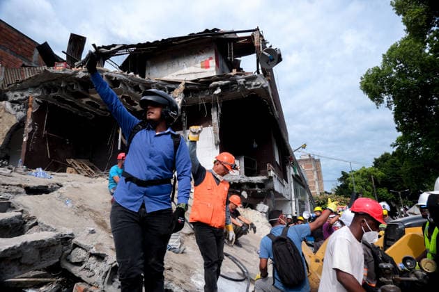 August 12, 2026, Cali, Valle Del Cauca, Colombia: People gather outside collapsed buildings in Cali, Colombia on August 12, 2026 to aid in several rescue labors after a 7,4 magnitude earthquake that struck the cities of Quibdo, Cali, Pereira and Manizales leaving more than 200 casualties past august 10. Cali Colombia - ZUMAvp1_ 20260812_zia_vp1_001 Copyright: xMartinxStevenxAngelx