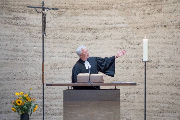 Thomas Jeutner, pastor at the Chapel of Reconciliation, during his welcoming remarks at the 65th anniversary commemoration of the construction of the Berlin Wall on August 13, 2026, at the Chapel of Reconciliation, Berlin Wall Memorial, Berlin, Germany; Berlin Wall Memorial, Ka