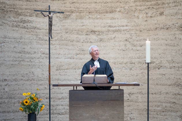 Thomas Jeutner, pastor at the Chapel of Reconciliation, during his welcoming remarks at the 65th anniversary commemoration of the construction of the Berlin Wall on August 13, 2026, at the Chapel of Reconciliation, Berlin Wall Memorial, Berlin, Germany; Berlin Wall Memorial, Ka