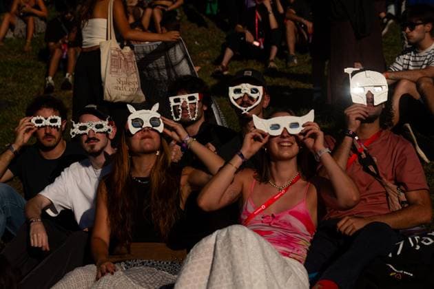 August 12, 2026, Paredes De Coura, Braga, Portugal: A group of festivalgoers wearing decorative eclipse glasses watch the partial solar eclipse on the opening day of Vodafone Paredes de Coura. Paredes De Coura Portugal  - ZUMAs197 20260812_aaa_s197_598 Copyright: xDiogoxBaptistax