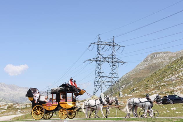 August 13, 2026 Switzerland Nostalgic Stagecoach Photo, Gotthard Post, Historic stagecoach ride from Andermatt over the Gotthard Pass via the Tremola Road to Airolo, passing a high-voltage power pole