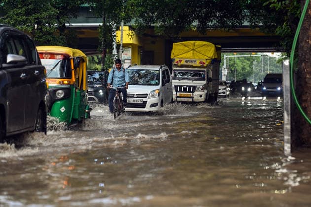 Heavy rain lashes parts of the National Capital New Delhi, Aug 13 (ANI): Commuters wade through a waterlogged road near SIR M. Vishweshwariah Moti Bagh metro station following heavy rainfall, in New Delhi on Thursday. New Delhi Delhi India Copyright: xANIx ANI_20260813266