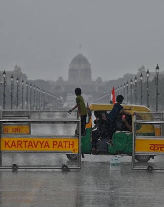 Heavy rain lashes parts of the National Capital New Delhi, Aug 13 (ANI): Children climb onto a barricade near India Gate amid heavy rainfall, in New Delhi on Thursday. New Delhi Delhi India Copyright: xANIx ANI_20260813301