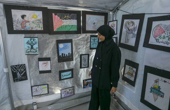 Palestinian children reflect war, displacement and hope through Art in Khan Yunis KHAN YUNIS, GAZA , PALESTINE - AUGUST 13: Works by Palestinian children are brought together in the exhibition held inside a tent at a refugee camp in the Al-Mawasi area of Khan Yunis, Gaza, Palestine on August 13, 2026. Created amid the severe humanitarian conditions resulting from the attacks that have continued since Oct. 2023, the artworks depict the children s experiences of displacement, destruction, hunger, water shortages and the loss of loved ones. Abed Rahim Khatib Anadolu Han Yunus Palestinian Territory, Occupied. Editorial use only. Please get in touch for any other usage. Copyright: x2026xAnadoluxAbedxRahimxKhatibx
