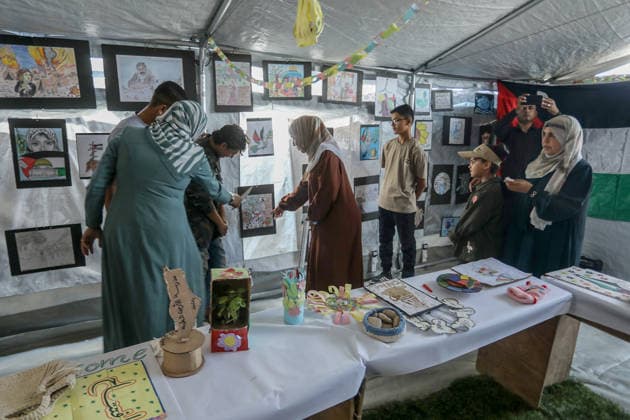 Palestinian children reflect war, displacement and hope through Art in Khan Yunis KHAN YUNIS, GAZA , PALESTINE - AUGUST 13: Works by Palestinian children are brought together in the exhibition held inside a tent at a refugee camp in the Al-Mawasi area of Khan Yunis, Gaza, Palestine on August 13, 2026. Created amid the severe humanitarian conditions resulting from the attacks that have continued since Oct. 2023, the artworks depict the children s experiences of displacement, destruction, hunger, water shortages and the loss of loved ones. Abed Rahim Khatib Anadolu Han Yunus Palestinian Territory, Occupied. Editorial use only. Please get in touch for any other usage. Copyright: x2026xAnadoluxAbedxRahimxKhatibx