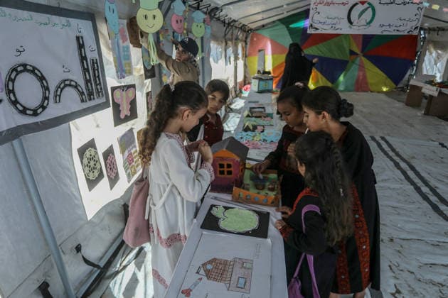 Palestinian children reflect war, displacement and hope through Art in Khan Yunis KHAN YUNIS, GAZA , PALESTINE - AUGUST 13: Works by Palestinian children are brought together in the exhibition held inside a tent at a refugee camp in the Al-Mawasi area of Khan Yunis, Gaza, Palestine on August 13, 2026. Created amid the severe humanitarian conditions resulting from the attacks that have continued since Oct. 2023, the artworks depict the children s experiences of displacement, destruction, hunger, water shortages and the loss of loved ones. Abed Rahim Khatib Anadolu Han Yunus Palestinian Territory, Occupied. Editorial use only. Please get in touch for any other usage. Copyright: x2026xAnadoluxAbedxRahimxKhatibx