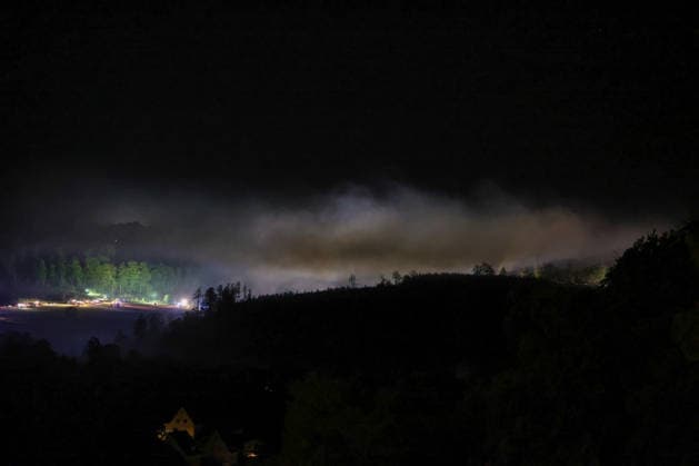 Helminghausen, Marsberg, North Rhine-Westphalia, Germany, Europe: Thick smoke drifts over the forest during a nighttime wildfire operation near the Diemel Dam. In the background, fire trucks and emergency responders are working along the scene of the fire, while spotlights and blue lights illuminate the smoke and the edge of the forest. Copyright: xAymanxAlahmedx