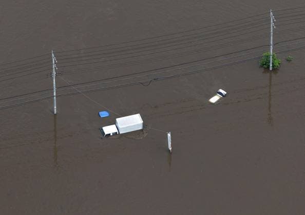 Aftermath of torrential rain in eastern Japan Photo taken from a Kyodo News helicopter on Aug. 14, 2026, shows vehicles submerged in floodwater in Sakura in Chiba Prefecture, east of Tokyo, after torrential rain overnight. Japan s weather agency issued its highest Level 5 warning in parts of the prefecture.  A14AA0005625751P