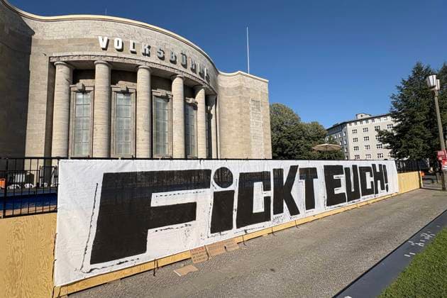 August 14, 2026: The Volksbühne Berlin set up a temporary, free swimming pool on Rosa Luxemburg Platz—the Volksbad —featuring a banner reading Fickt Euch, Fuck You following protests against a private event for Black people, Berlin, Germany