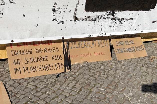 August 14, 2026: The Volksbühne Berlin set up a temporary, free swimming pool on Rosa Luxemburg Platz—the Volksbad —featuring a banner reading Fickt Euch, Fuck You following protests against a private event for Black people, Berlin, Germany