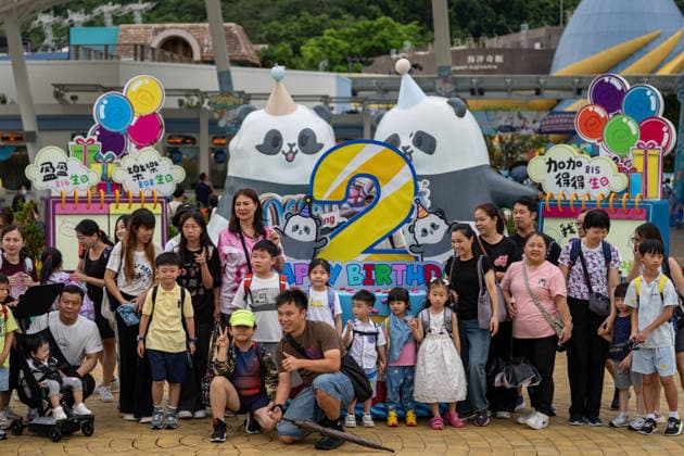 Hong Kong Panda Twins Mark 2nd Birthday Visitors taking photos with a display themed after the panda twins 2nd birthday at the entrance of Hong Kong Ocean Park on August 14, 2026 in Hong Kong. The Hong Kong Panda twins today celebrated their 2nd birthday. (Photo by Vernon Yuen Nexpher Images) HONG KONG
