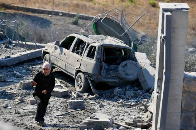 (260815) -- ANSAR, Aug. 15, 2026 -- A woman inspects the damage after an Israeli airstrike on the outskirts of Ansar in the southern Nabatieh Governorate, Lebanon, Aug. 15, 2026. At least seven people were killed and three others injured early Saturday in an Israeli airstrike on a building on the outskirts of Ansar in the southern Nabatieh Governorate, Lebanon s National News Agency reported. (Photo by Xinhua) LEBANON-ANSAR-ISRAELI AIRSTRIKE-AFTERMATH AlixHashisho 