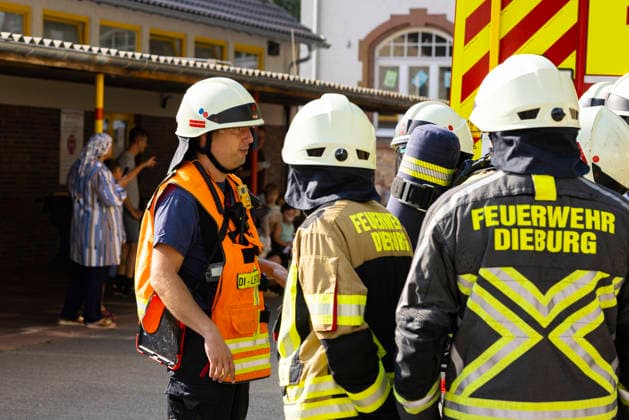 Großübung der Feuerwehr an der Marienschule in Dieburg Großübung der Feuerwehr unter realistischen Einsatzbedingungen an der Marienschule in Dieburg am 15. August 2026, simulierter Brand in der Grundschule in der Marienstraße, Alarmierung und Anfahrt der Einsatzkräfte unter Einsatzbedingungen, rund 50 beteiligte Einsatzkräfte nach Beobachtung vor Ort, mehrere Feuerwehr- und Einsatzfahrzeuge sowie eine Drehleiter im Einsatz, simulierte Menschenrettung aus dem Schulgebäude, Mitglieder der Jugendfeuerwehr als vermeintlich verletzte beziehungsweise zu rettende Personen, Rettung und Versorgung der simulierten Brandopfer, zwei Rettungswagen im Rahmen der Einsatzübung vor Ort, Zusammenarbeit von Feuerwehr und Rettungsdienst, Übung von Br