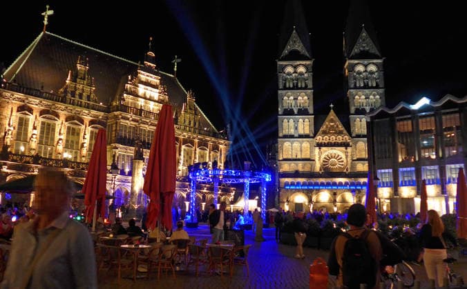 Bremen’s Market Square on the opening night of the 37th Bremen Music Festival on August 15, 2026, under the theme A Grand Night of Music. On the left is the historic City Hall; on the right are Bremen Cathedral and the Bremen City Parliament.
