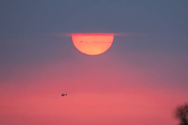 A reddish sun over the Rhineland; view from Petersberg, August 15, 2026; view from Petersberg in Königswinter of the setting sun over the Rhineland. Smoke from the forest fires in the Hohen Venn and the Hürtgen Forest spreads across the sky, maki Copyright: xMarcxJohnx