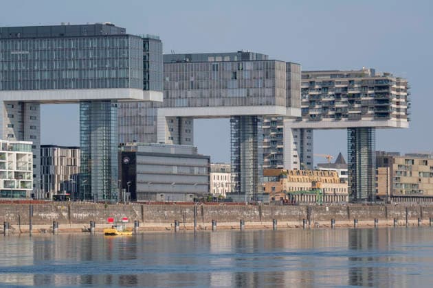 A wide shot captures Kranhaus buildings (Kranhaus Eins, Kranhaus Süd, and Pandion Vista) in the historic Rheinauhafen district. The extraordinary architecture shaped like an inverted L, which resembles historical harbor crane structures, characterizes the modern cityscape along the Rhine bank. Nordrhein-Westfalen Deutschland, Germany GMS20681