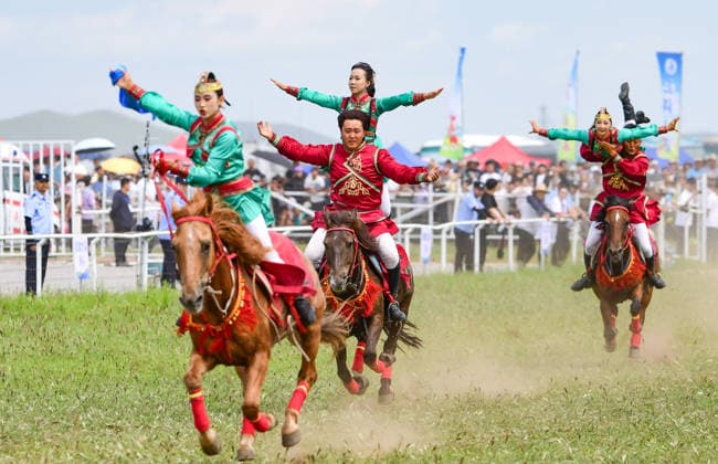 (260816) -- HINGGAN LEAGUE, Aug. 16, 2026 -- People perform equestrian skills at the opening ceremony of a Nadam fair in Jalaid Banner of Hinggan League, north China s Inner Mongolia Autonomous Region, Aug. 16, 2026. The Nadam fair opened here on Sunday, featuring equestrian performances, songs and dances, instrumental music and traditional folk performances. (Photo by Xinhua) CHINA-INNER MONGOLIA-NADAM FAIR (CN) WangxZheng 
