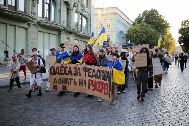 August 16, 2026, Odessa, Ukraine: Activists hold placards expressing their opinions and Ukrainian flags on during the rally Deribasovskaya Street. A march in support of former Defense Minister Fedorov passed through the central streets of Odessa. Activists are demanding that Mykhailo Fedorov should be reinstated as Defense Minister. He was dismissed a month ago by the Ukrainian president. Similar marches have taken place across Ukraine. Odessa Ukraine - ZUMAs197 20260816_aaa_s197_218 Copyright: xViacheslavxOnyshchenkox