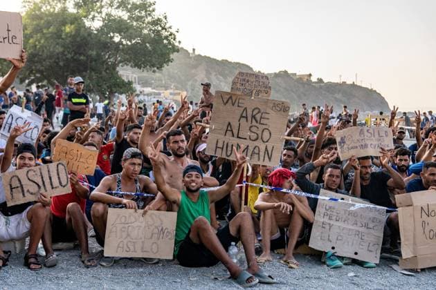 August 17, 2026, Ceuta, Spain: CEUTA, SPAIN Ã¢â‚¬ AUGUST 17, 2026: More than 100 migrants, most of them Moroccan, have been protesting for days in front of National Police vans during the daily food distribution provided by the Spanish Red Cross at TrampoloÂ­n Beach. Ã¢â‚¬oeNo asylum, no foodÃ¢â‚¬Â is the chant repeated by the migrants on the sand, while African migrants continue to stay in the temporary accommodation facilities set up on the Ceuta beach. Authorities are expected to clear the beach in the coming days and transfer the migrants to four reception facilities announced today by SpainÃ¢â‚¬â ¢s Minister for Migration, Elma Saiz. Ceuta Spain  - ZUMAq101 20260817_zna_q101_081 Copyright: xAntonioxSemperex