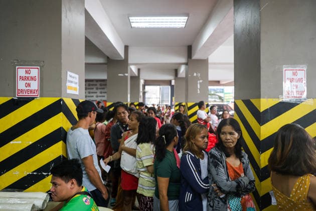 Tens of thousands evacuated in Philippines amid monsoon rains, floods QUEZON CITY, PHILIPPINES - AUGUST 18: People evacuated from flooded areas wait in queue to collect food and supplies at a secondary school-turned emergency shelter, amid lingering threats of flooding caused by heavy monsoon rains, in Quezon City, Metro Manila, Philippines, on August 18, 2026. As the country remains threatened by floods caused by monsoon heavy rains, tens of thousands of people in the capital region of Metro Manila and its surrounding cities and areas have been evacuated, with schools in multiple locations across the Philippines being suspended for safety reasons. Daniel Ceng Anadolu Quezon City Philippines. Editorial use only. Please get in touch for an Copyright: x2026xAnadoluxDanielxCengx