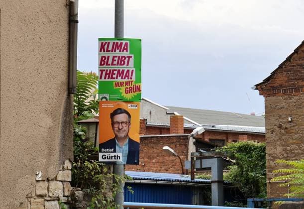 Election posters, August 18, 2026, Aschersleben, election posters for the state election on September 6, 2026, in Saxony-Anhalt shown here: election posters stacked on top of each other on a lamppost, here from Alliance 90 The Greens. Climate remains an issue. Only with the Greens and the CDU—Detlef Guerth
