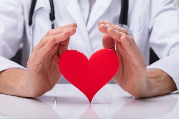 Close-up Of A Doctor s Hand Protecting Red Heart Shape model released Symbolfoto Copyright: xAndreyPopovx Panthermedia76772278.jpg