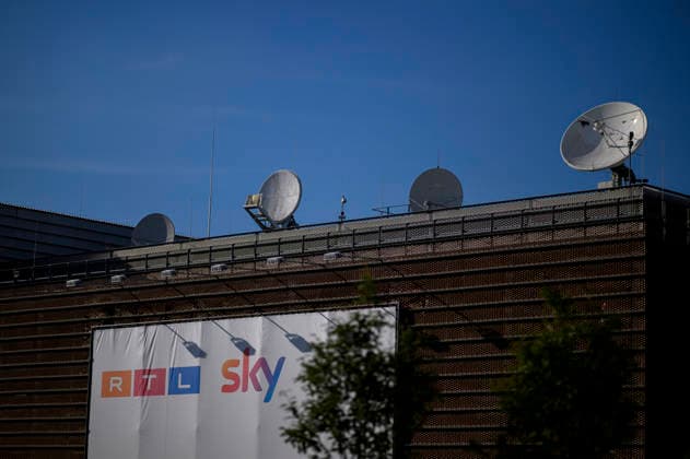 RTL Deutschland headquarters at Rheinpark Metropole, featuring a banner with the RTL and Sky logos and a satellite dish on the roof, on August 26, 2026, in Cologne, Germany