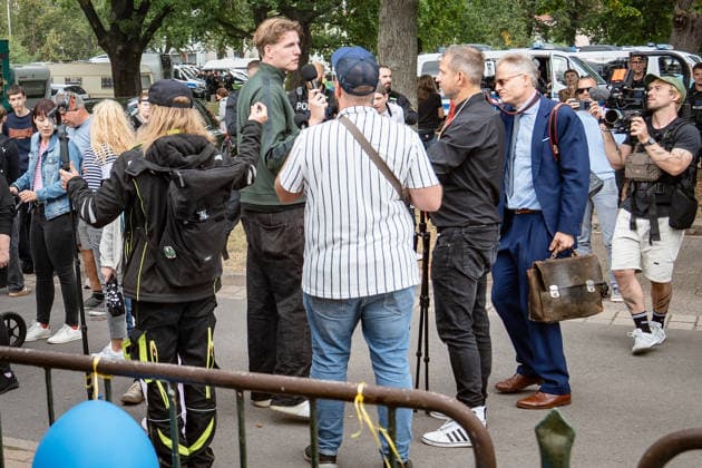 YouTuber and streamer Matthäus Westfal, known as the activist Man in the Blue Cap, Marcant in the green jacket, and Sebastian Weber, known as Weichreite TV in the black cap, on the sidelines of the AfD Democracy Festival campaign event in Haldensleben for the 2026 Saxony-Anhalt state election, Haldensleben, Saxony-Anhalt, Germany; the Schützenhaus of the Schützengilde