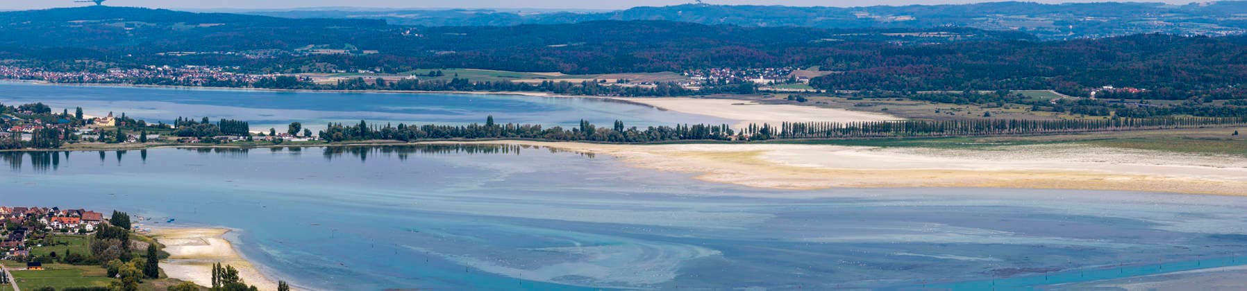 View of Reichenau Island in Lake Constance. On the right is the Reichenau Embankment with its avenue of plane trees, part of the German Allenstraße. The lakeshore reveals the low water level following a hot summer. August 27, 2026, Ermatingen, Canton of Thurgau, Switzerland