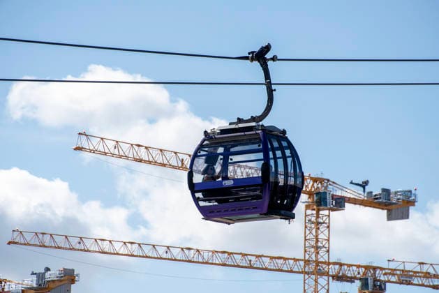September 5, 2026, London, United Kingdom: A passenger waves to the camera from the cabin while she travels by the London Cable Car Experience. The London Cable Car Experience (officially the IFS Cloud Cable Car) is an aerial transit and leisure attraction that carries passengers in gondolas 90 meters (300 feet) above the River Thames. It connects the Greenwich Peninsula (near The O2) and the Royal Docks (near ExCeL London) in East London. It offers a panoramic view to the Thames Barrier, London Skyline and the Canary Wharf. London United Kingdom  - ZUMAs197 20260905_aaa_s197_1163 Copyright: xKrisztianxElekx