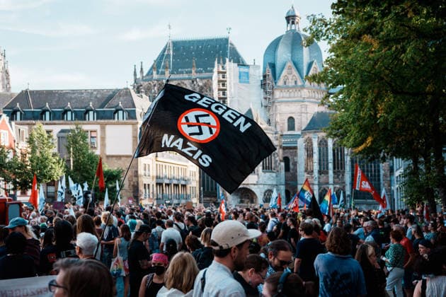 Germany, Aachen Katschhof: Rally with thousands of people the day after the state election in Saxony-Anhalt; demonstration, protest, anti-AfD, anti-fascism, signs, banners, posters, Against Nazis flag from Aachen Cathedral Copyright: xThiemoxRudolphx