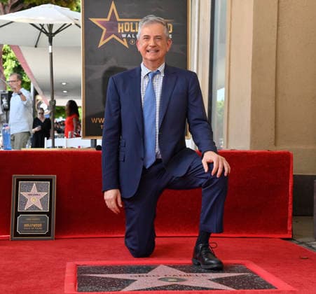 American screenwriter, television producer and director Greg Daniels kneels next to his star during an unveiling ceremony honoring Daniels with the 2,856th star on the Hollywood Walk of Fame in Los Angeles on Thursday, September 10, 2026.  LAP2026091009 JIMxRUYMEN
