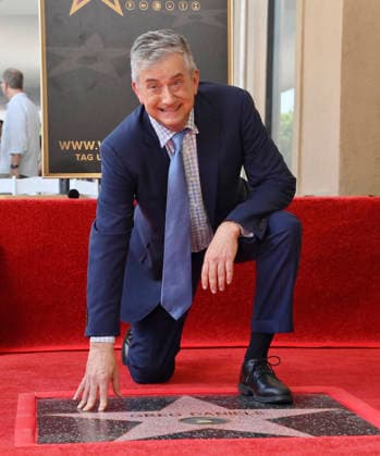 American screenwriter, television producer and director Greg Daniels kneels next to his star during an unveiling ceremony honoring Daniels with the 2,856th star on the Hollywood Walk of Fame in Los Angeles on Thursday, September 10, 2026.  LAP2026091010 JIMxRUYMEN