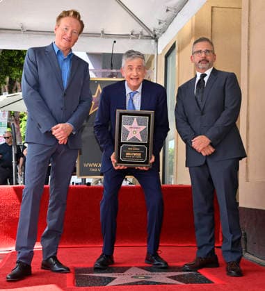 American screenwriter, television producer and director Greg Daniels holds a replica plaque as Conan O Brien (L) and Steve Carell look on during an unveiling ceremony honoring Daniels with the 2,856th star on the Hollywood Walk of Fame in Los Angeles on Thursday, September 10, 2026.  LAP2026091017 JIMxRUYMEN