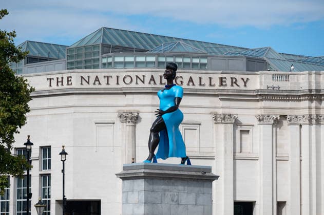 September 12, 2026, London, United Kingdom: Sculpture Lady in Blue with the National Gallery in the background in Trafalgar Square, London. Lady in Blue, a bronze sculpture by New York-based artist Tschabalala Self, stands on the Fourth Plinth in Trafalgar Square, London. Unveiled on 10 September, the work pays homage to a young metropolitan woman of colour and was created as a contemporary everywoman representing the diversity of London today. The sculpture explores themes of representation, recognition and equity, presenting an everyday woman walking forward into a shared future rather than a traditional historical figure or monument. The bronze sculpture is patinated in Lapis Lazuli blue, a pigment with a long history across North - ZUMAs197 20260912_aaa_s197_276 Copyright: xAndreaxDomeniconix