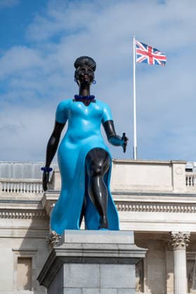 September 12, 2026, London, United Kingdom: Sculpture Lady in Blue with the British Flag in the background in Trafalgar Square, London. Lady in Blue, a bronze sculpture by New York-based artist Tschabalala Self, stands on the Fourth Plinth in Trafalgar Square, London. Unveiled on 10 September, the work pays homage to a young metropolitan woman of colour and was created as a contemporary everywoman representing the diversity of London today. The sculpture explores themes of representation, recognition and equity, presenting an everyday woman walking forward into a shared future rather than a traditional historical figure or monument. The bronze sculpture is patinated in Lapis Lazuli blue, a pigment with a long history across North Afri - ZUMAs197 20260912_aaa_s197_278 Copyright: xAndreaxDomeniconix